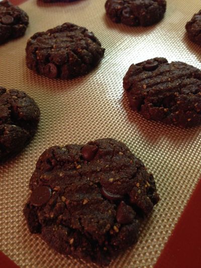 Chocolate chocolate chip cookies on a baking sheet.