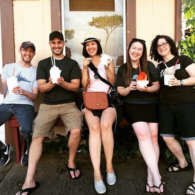 Members of Theam Team, standing together, holding and enjoying shaved ice in Hawaii.