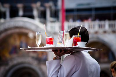 Waiter serving beverages.