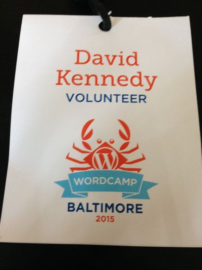 WordCamp Baltimore 2015 conference badge with a cartoon crab in the center and the words David A. Kennedy, volunteer, WordCamp Baltimore 2015.